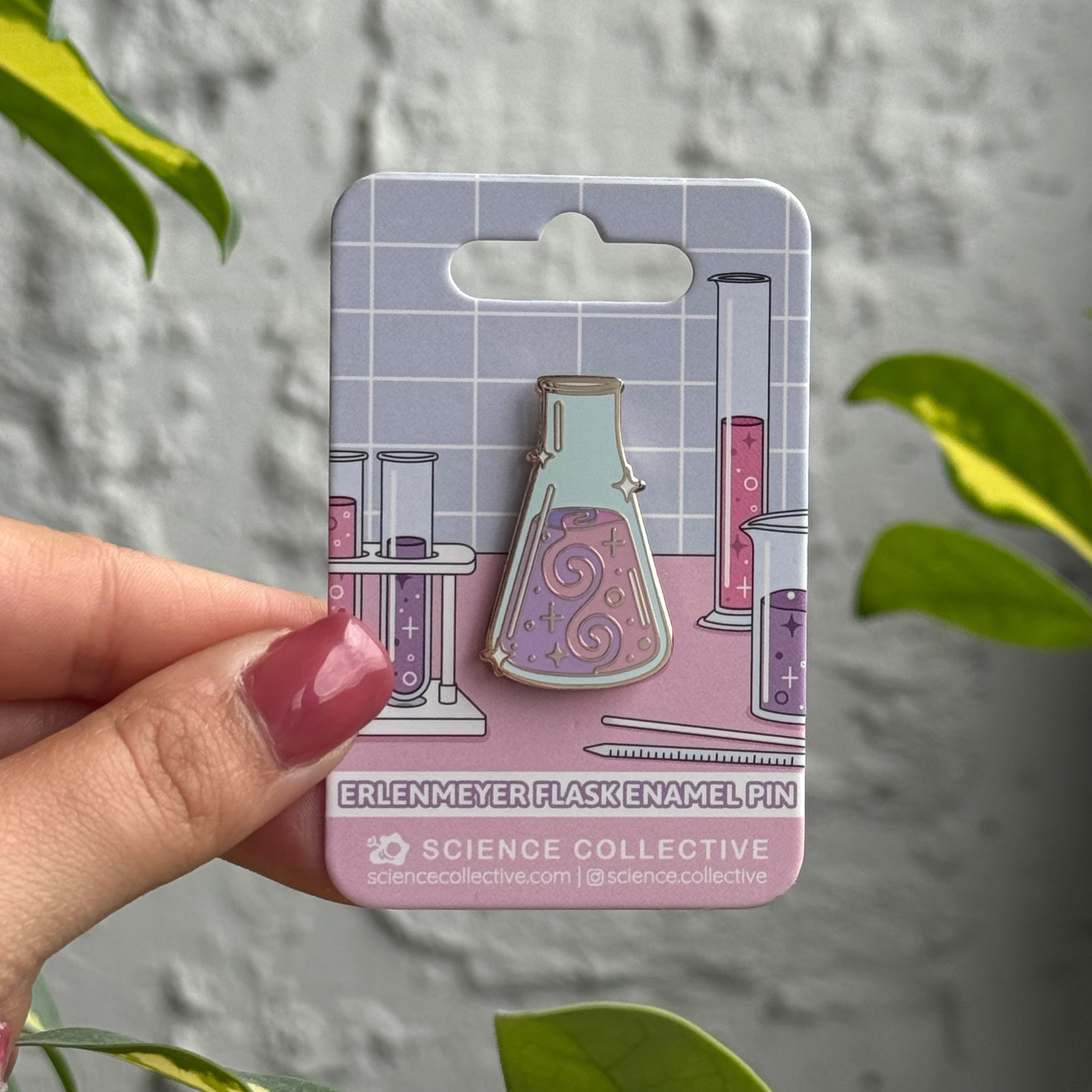 Chemistry enamel pin featuring an erlenmeyer flask.