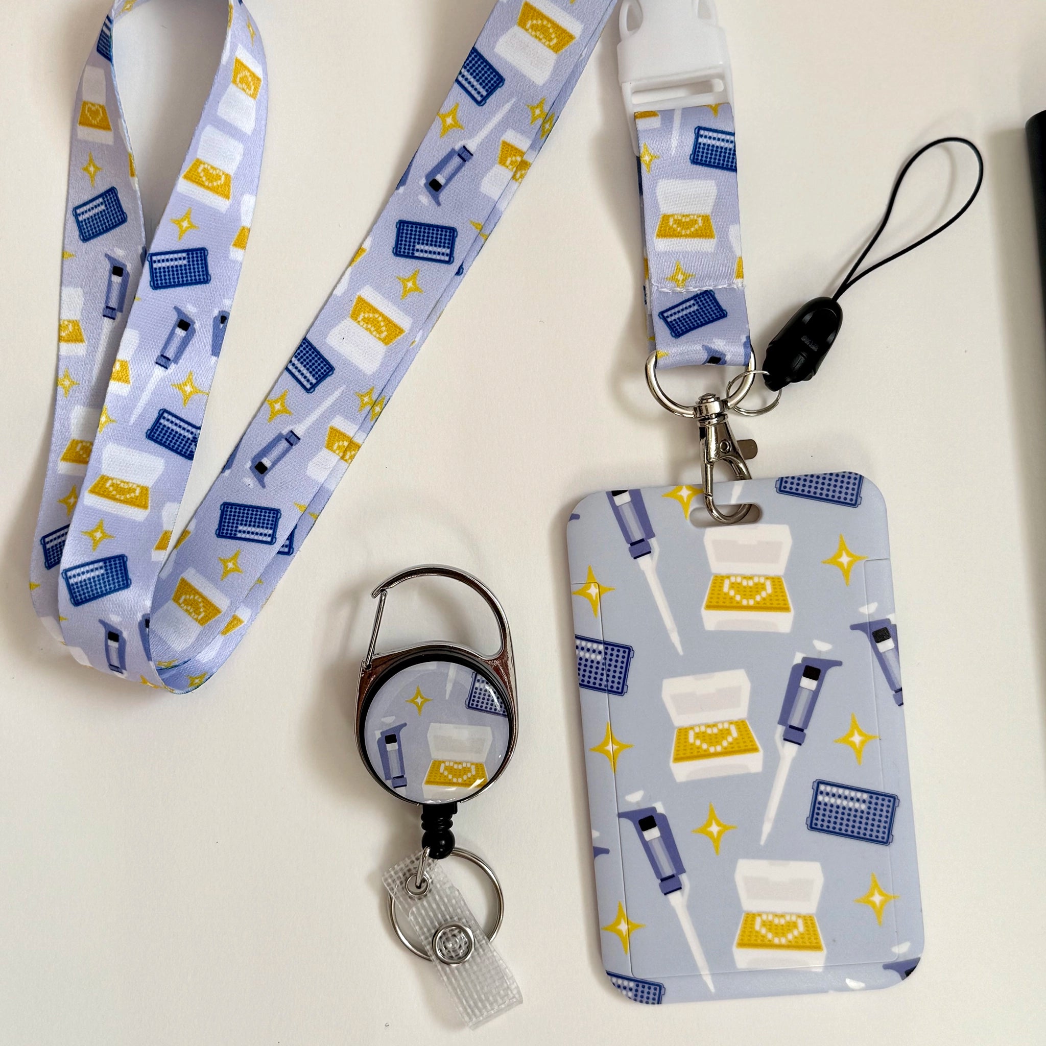 Micropipette card holder set including a lanyard, card holder, and retractable badge reel.