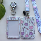 Chemistry lanyard, badge holder, and retractable badge reel featuring a pattern of whimsical pink and purple chemistry flasks and tubes.
