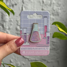 Chemistry enamel pin featuring an erlenmeyer flask.